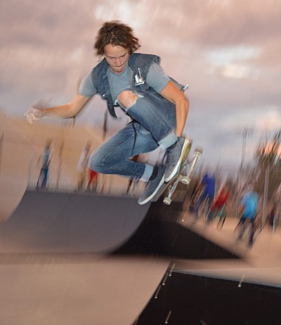 A skateboarder flies through the air at the Winslow Skateboard Park July 11. Photo/Todd Roth