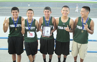 The Tuba City High School boys cross country team celebrates after winning the Hopi Invite boys race Sept. 2 at Bruins Stadium. Photo/Stan Bindell