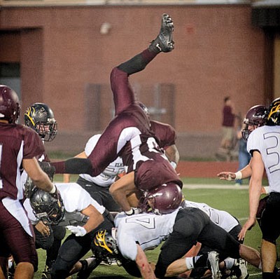 A Winslow Bulldog flips over Round Valley players Sept. 12. Despite the effort, Round Valley prevailed 42-8. Photo/Todd Roth