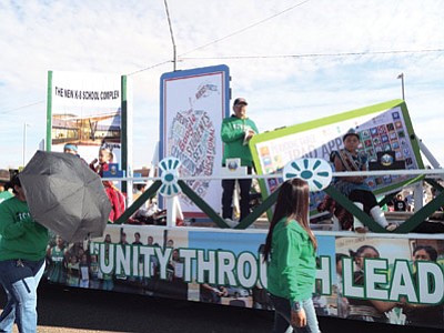 Tuba City Unified School District transportation staff put together a flatbed float to show the technology changes and upgrades that would be possible with with voter approval of a construction bond. The bond passed in the Nov. 4 election. Tuba City School Board member Lee Tsinigine stands at the center of the float during the Western Navajo Nation Fair parade in Tuba City—Moencopi. Photo/Rosanda Suetopka