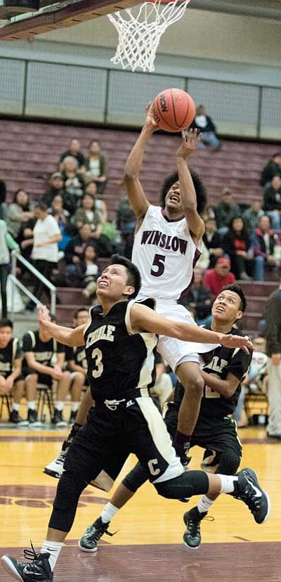 Devon Flanagan drives hard to the basket during the Winslow Bulldogs’ 64-62 win over the Chinle Wildcats Dec. 16.  Photo/Todd Roth