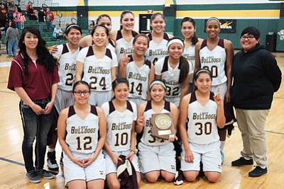 The Winslow Lady Bulldogs basketball team celebrate after winning the sectional tournament on Feb. 13. Winslow beat Holbrook 63-52. Photo/Todd Roth