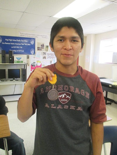 Hopi High School wrestler Adam Laban displays his sectional tournament first in weight class medal. Photo/Stan Bindell