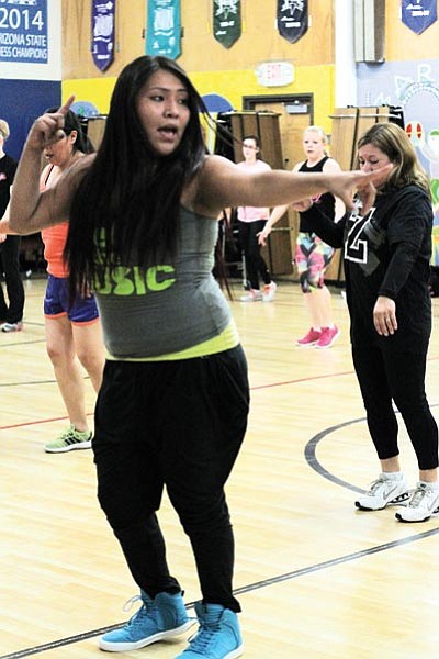 Above and below: Zumba instructor Berta Descheny leads a fitness class at Killip Elementary School in Flagstaff. She hopes to bring the popular fitness program to the reservation. Loretta Yerian/NHO
