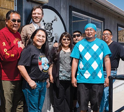 KUYI Hopi Radio staff and volunteers stand outside the station located in Keams Canyon, Arizona. From left: Bruce Talawyma, Station Manager Richard Davis, Romalita Laban, Trina Kagenveama, Emil Batala, Thomas Humeyestewa and Tim Nuvangyaoma. Below: DJ Lana (Humeyestewa) rocks the airwaves. Ryan Williams/NHO