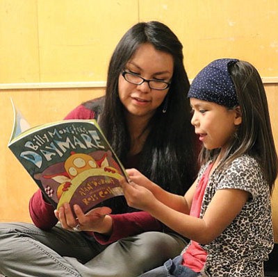 Natasha Fulton reads to Marquisha, a kindergarten student at Kinsey School in Flagstaff. Photo/Theresa Bierer