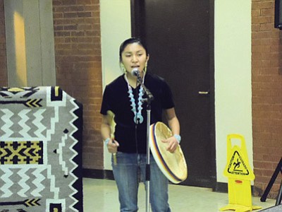 Tuba City High School student Mia Keeswood performs a song she wrote using a hand drum as accompaniment. She takes her Navajo language seriously enough to use in it her own creative process. Keeswood is an example of learning