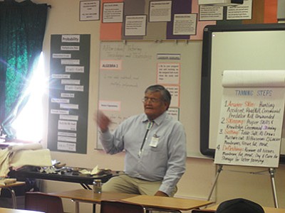 Floyd Stevens, a member of the Navajo Nation and one of 20 Native scholars who presented at a district-wide cultural Symposium at Tuba City High School Jan. 20, discusses Traditional Tanning Processes: Hunting Do’s and Don’ts. Both Hopi and Navajo Native specialists shared their wisdom and expertise with school district staff members during the annual event. Photo/Rosanda Suetopka