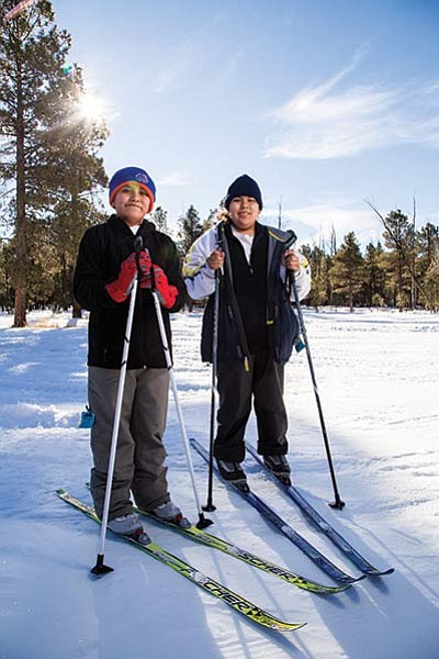 Josiah Chavez (left) and Cedric Yazzie take a break from training at Flagstaff’s Nordic Center for cross country Special Olympics skiing competition. Ryan Williams/NHO