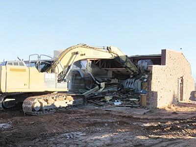 Demolition of the library and classroom areas takes place at Eagles’ Nest school in Tuba City, Arizona. Much of the original Moencopi sandstone brick has been salvaged for future design projects. Photo/Rosanda Suetopka