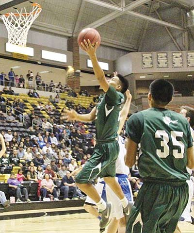 Tuba City Warrior Davean Yazzie (24) drives in the paint to score at the Chinle Wildcat Den. The Snowflake Lobos defeated the Warriors 53-51 during the AIA Division III Section I boys basketball tournament Feb. 12. Photo/Anton Wero