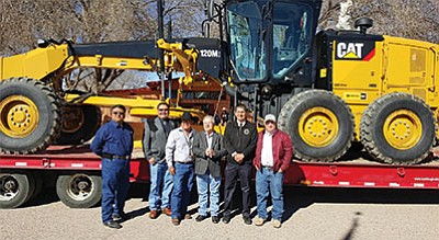 Navajo Nation Council Delegate Edmund Yazzie and Navajo Nation Vice President Jonathan Nez stand with Iyanbito Chapter officials and New Mexico legislators March 11 in front of a new road grader. Submitted photo