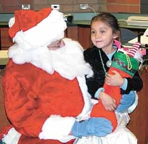 Photo by TC Media Team, 
Making the trip all the way from Flagstaff to Gap, this Santa brought gifts to the architecturally award-winning school, Tsinaabaas Habitiin, one of the seven schools that belongs to TCUSD #15.