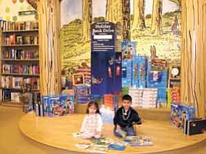 Photo courtesy NACOG Head Start
Genesis Begay, 19 months, and Brennen Neztsosie, age 4, who attends Cogdill Head Start in Flagstaff, are pictured at the Barnes & Noble Holiday Book Drive display.

