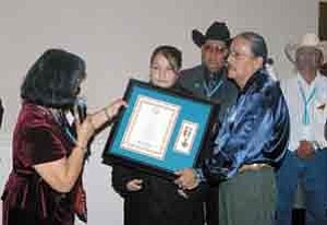 Courtesy photo.Angela Barney Nez (left) and Young Jeff Tom present the Medal of Valor.