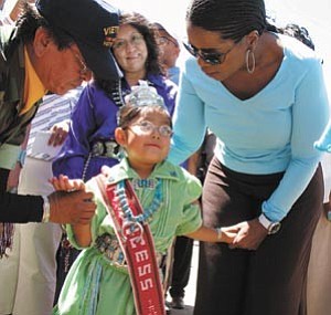 Photo by George Hardeen
Gibson Jones of Tuba City, left, and Oprah Winfrey help guide a little Navajo princess through the crowd to prevent her from being overrun by the many fans wanting a closer look at the star. Navajo Nation First Lady Vikki Shirley is standing behind the princess.