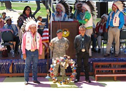 Photo by George Hardeen 
Tex Hall, chairman of the Mandan, Hidatsa and Arikara Tribe, Lt. Col. Rick Steiner of the 10th Special Forces Group, and Navajo President Joe Shirley, Jr., lay a wreath at the wall of the Apsáalooke Veterans Commemorative Park on June 23 at the Crow Agency, Montana.
