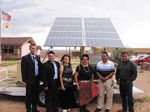 S.J. Wilson/Observer
Michael Elliot, left, David Melton, Rayola Werito, Chapter Delegate Evelyn Acothley, Teddy Bedonie and Jack Colorado stand in front of the New Mexico model of Sacred Power Corp’s solar settup. The Cameron model will include a wind turbine instead of a propane generator and a refrigerator.
