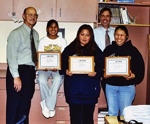 Hopi High School journalists display their Arizona Interscholasic Press Association awards. Pictured from left are: Superintendent Paul Reynolds, award recipients DeAnn Honanie, Marice Lalo and Madeline Jackett, and principal Glenn Gilman (Photo by Stan Bindell/The Observer).