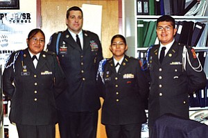 Hopi JROTC cadet leaders posed with inspector Mark
Ehresman. From left are, Ronisha Lopez, Ehresman, Lauren Lomatska and Jeremy Naha (Photo by Stan Bindell/Observer).