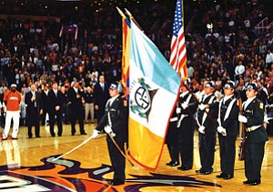 The Hopi High JROTC squad posts colors as members of the Phoenix Suns and the crowd look on (Photo by Stan Bindell).