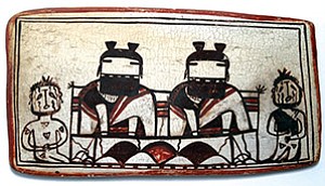 This Hopi tile is from the Nelle Dermont Collection, c. 1900. Arizona State Museum. It depicts two kachina maidens grinding corn at a mealing bin. The maidens are flanked by Heheya-aumutaqua (uncle) kachinas.