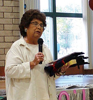 Lolita Tsinnie, a 45-year employee with the Tuba City Unified School District (TCUSD), speaks to fellow co-workers and other honorees at a TCUSD employee recognition dinner held May 15 (Photo by Rosanda Suetopka Thayer).
