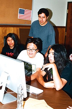 Filmmakers Bennie Klain (sitting, center) and Tim Ramos show Salt River students how to make films (Photo by Stan Bindell).