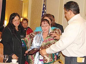 Native Americans for Community Action Workforce Investment Act participant and employee Pamela Jensen (center) was recently recognized at the national level for her strengths, determination and outstanding abilities. She received the National Indian and Native American Employment and Training Administration (NINAET) 2007 Outstanding Participant of the Year in Newport, R.I., and was honored with a plaque and Pendleton blanket (Courtesy photo).