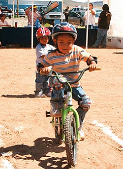 Cordell T. Begay, age 4, of Teesto begins his ride on the bike safety course during the bike rodeo on June 19, 2007 in Dilkon (Courtesy photo)