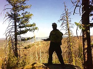 Cherokee firedancer Frank Roof pauses for a moment to survey damage from a recent fire near Boise, Idaho (Courtesy photo).