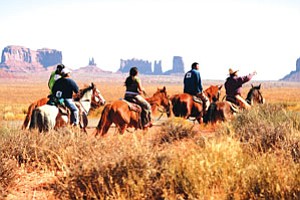 From left: Bonnie Crank, Gloria Clah and Monique Crank catch up with two unidentified male riders during the horseback ride that was part of the Raising the Bar to Exercise event held in Monument Valley Oct. 19. The horseback ride covered 15.5 miles from Oljato Chapter House to Monument Valley Park (Photo by Ray Baldwin Louis/NNSDP).