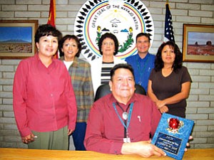 Standing from left: Rena Dodson, Human Resource director; Marie Morales, Federal Project director; Stella Claw, Navajo Language teacher; Dwight Witherspoon, Dean of Students; Trevia Knight business manager and Andrew Tah superintendent (seated; Photo by Josepine Billy).