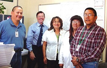 From left to right: Vincent Shirley, TCRHCC Compliance Officer; Joseph Engelken, TCRHCC CEO; Shirley Peaches, TCRHCC Safety Officer; Pam James, TCUSD Support Services Administrative Asst.; Ron Begay, Construction Supervisor and Safety Officer for TCUSD. TCUSD and TCRHCC are the principal community partners for Tuba City and Hopi villages of Upper and Lower Mungapi in its annual mock disaster preparedness drill. This year, their safety team will participate in a mass flu vaccination exercise on Nov. 29 at the TC High Warrior Pavilion giving free flu shots from 7 a.m. to 12 p.m. (Photo by Rosanda Suetopka Thayer/TCUSD)