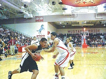 Chinle’s Denzel Harvey (43) drives the lane during the Wildcats’ win over the Monument Valley Mustangs in Kayenta in 3A North Region action over the weekend (Photo by Anton Wero/NHO).
