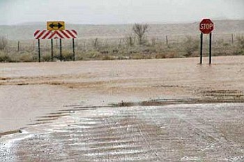 Floodwaters flow along a road at an unidentified location within the Bird Springs Chapter last week. Many chapters in northern Arizona and New Mexico have been hit hard by recent heavy snowstorms (Photo by Lt. Emerson Lee, NPD).