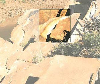 <i>Photo by Patrick Whitehurst/WGCN</i><br>
This photo shows the stolen section of rock art (highlighted) following the theft.