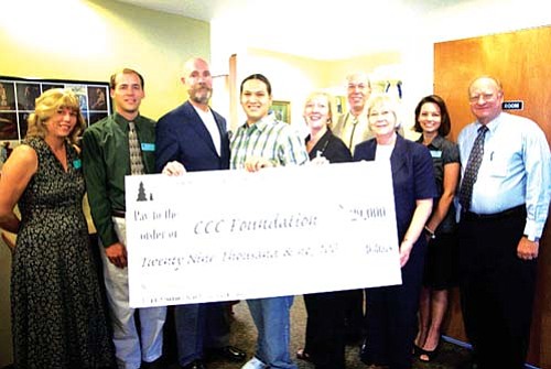 <i>Courtesy photo</i><br>
Raymond Educational Foundation members present Coconino Community College representatives with a giant check for $29,000 that will fund 29, $1,000 scholarships for CCC students. Pictured from left to right are CCC Assistant Director for Student Financial Assistance Lisa Hill, CCC Financial Assistance Director Bob Voytek, CCC Foundation President Chris Bavasi, CCC student and scholarship recipient Brenndon Tso, CCC President Dr. Leah L. Bornstein, Raymond Educational Foundation President Dr. Tom Montfort, Raymond Educational Foundation member Sarah Cromer, CCC Foundation Manager Cynthia Brown and CCC Foundation Director Robert Erb.