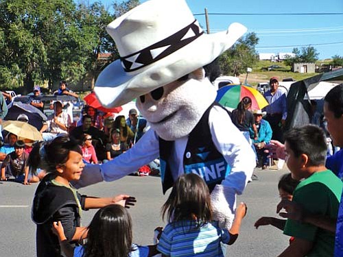 Ashkii Happy ("Happy Boy") greets a few youngsters during the 62nd annual Navajo Nation Fair parade held Saturday, Sept. 6.