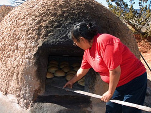 Woman baking bread in Jemez Pueblo.