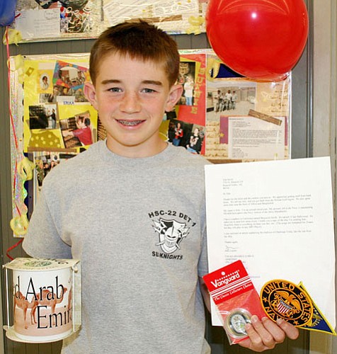 Trib Photo/Sue Tone<br>
To his surprise, Tim Smith, 13, received a package from John Lucero, aircraft electrician with the U.S. Navy, in response to a letter Tim wrote for Albertsons cookie sale this past year. Anyone can drop off letters for U.S. military personnel, which will be added to the cookie packages and mailed overseas on March 27.
