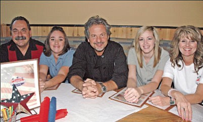 In a rare chance to sit down, Augie’s All American Eats owner Augie Perry, far left, poses with longtime staff members. Left to right are: Tesia Hurt, General Manager and Chef Alex Colaiani, Megan Christiansen and Sue Faucher.<br>
<i>Trib Photo/Cheryl Hartz</i>