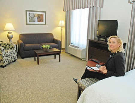 Zona Sweeney, general manager of Hampton Inn & Suites, relaxes in one of the hotel’s largest suites on opening day Monday in Prescott Valley.
TribPhoto/Cheryl Hartz
