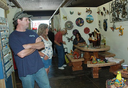 Shoppers to the indoor Red House Marketplace in Prescott Valley peruse a booth of patio items from Creative Iron Patio out of Surprise, Ariz.<br>
Photo Courtesy Cheryl Hartz