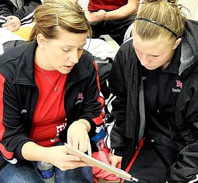 Biola University swim coach Brittany Sharpe, left, discusses team business with an assistant.<br>
Courtesy Photo