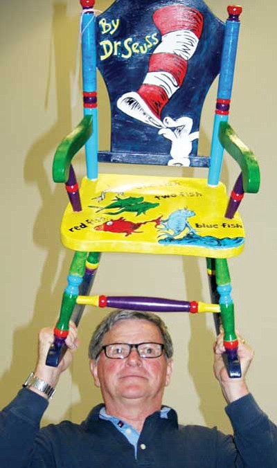 Former Arts and Culture Commissioner Dick Patton auctions off a Painted Chair at the 2010 Family Arts Festival.<br>
File Photo/Sue Tone