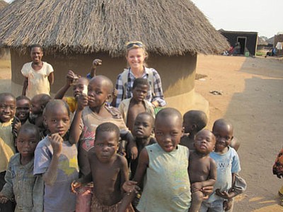 Bradshaw graduate (2007) Haylee Fletcher with Ugandan children during a research trip in 2011.<br>
Courtesy Photo