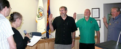 Dewey-Humboldt Town Magistrate Catherine Kelley, standing at left next to outgoing Mayor Len Marinaccio, swears in new council members, from left, Mark McBrady, John Dibbles, and David Hiles at the June 7 council meeting.<br>
Trib Photo/Sue Tone