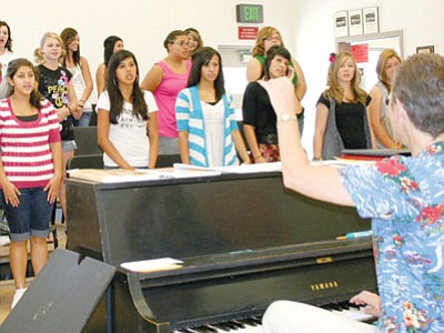 Bradshaw Mountain High School Choir Director Amy Van Winkle, right, runs through warm-up drills with a section of the Women’s Choir Monday morning. The school’s Choral Union is the sole program to benefit from donations at Saturday’s Acker on the Plaza event in Prescott.<br>
Trib Photo/Sue Tone