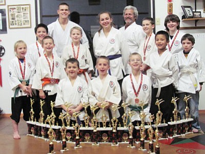 Back row l to r: Ceiley Plucinsky -  Kumite 1st, Kobudo 1st; Andrew Rojas - Kata 4th, Kumite 1st;  Shihan Alex - Kata 3rd, Kumite 1st, Kobudo 1st;  Mackenzie Donovan - Kata 2nd,  Kumite 1st;  Kyoshi Gary;  William Muller - Kata 2nd, Kumite 5th; Danielle Hamilton- Kumite 1st; Keenan Morris-Honorable Mention. Front/center row: Silas Snyder - Kata 3rd,  Kumite 4th; Brendan Penney - Kata 4th, Kumite 3rd; Dylan Donovan- Kata 1st, Kumite 1st; Trey Snyder- Kata 3rd, Kumite 3rd, Kobudo 3rd;  Fisher Plucinsky- Kata 1st;  Memphis James- Kata 3rd,  Kumite 1st.<br>
Courtesy Photo
